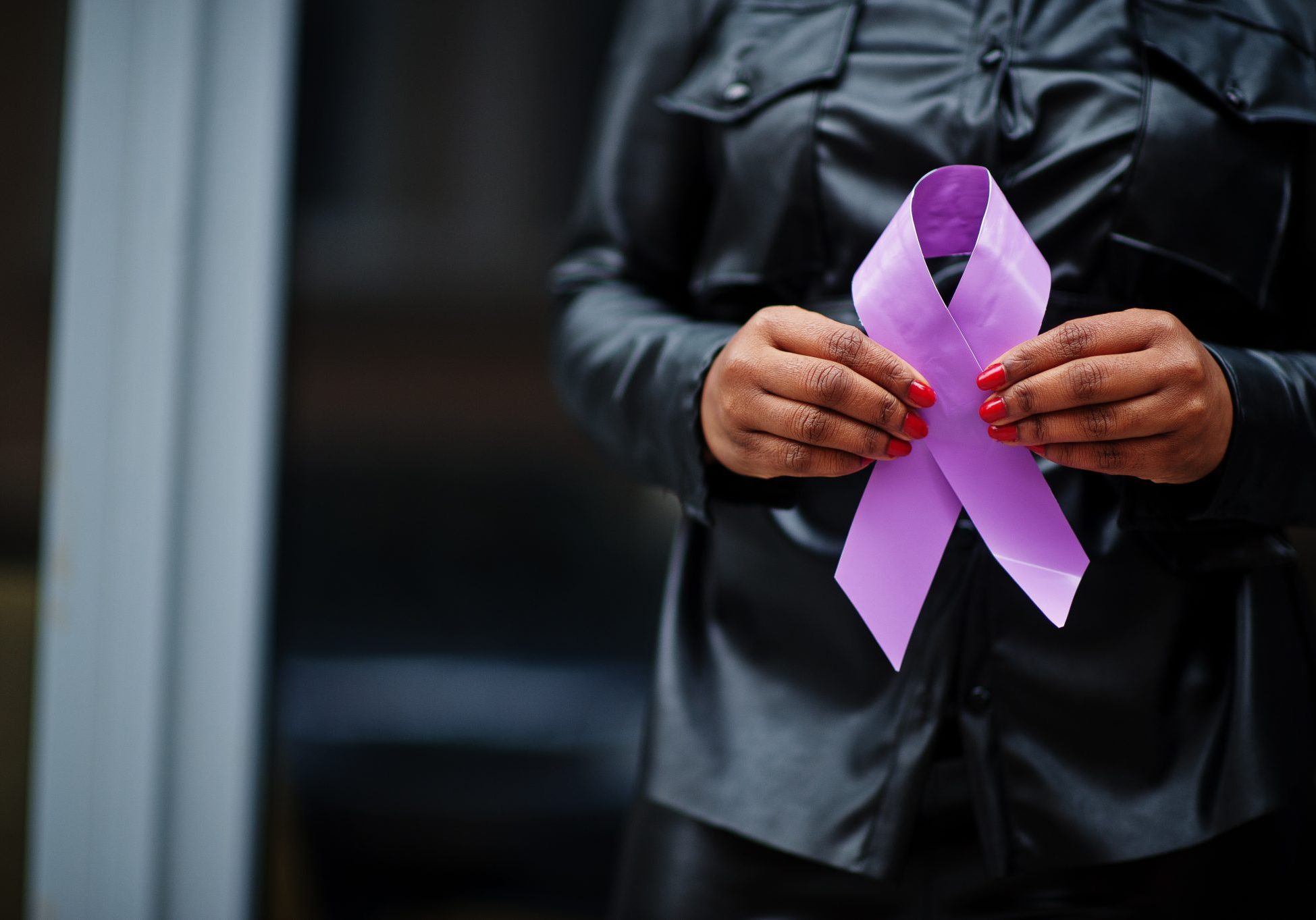 World Cancer Day concept, February 4. African american woman hold purple ribbon awareness.